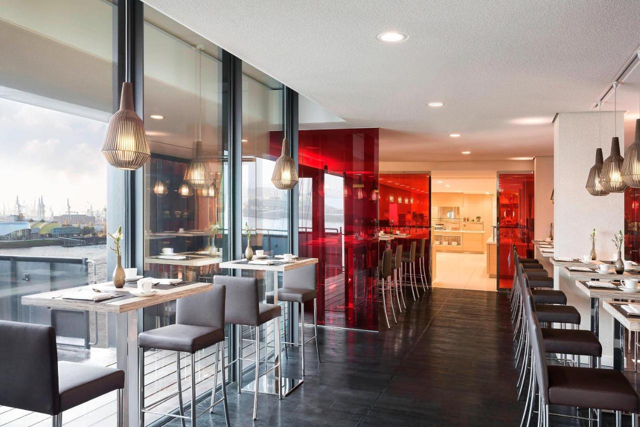 The Westin Hamburg Elbphilharmonie Hotel Екстериор снимка The photo showcases a modern restaurant interior characterized by sleek design and contemporary decor. The space features a combination of large windows allowing natural light to filter in, creating an open and airy atmosphere. The walls are accented